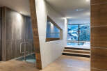 This luxurious spa boasts a stunning indoor pool with floor-to-ceiling windows offering breathtaking mountain views.