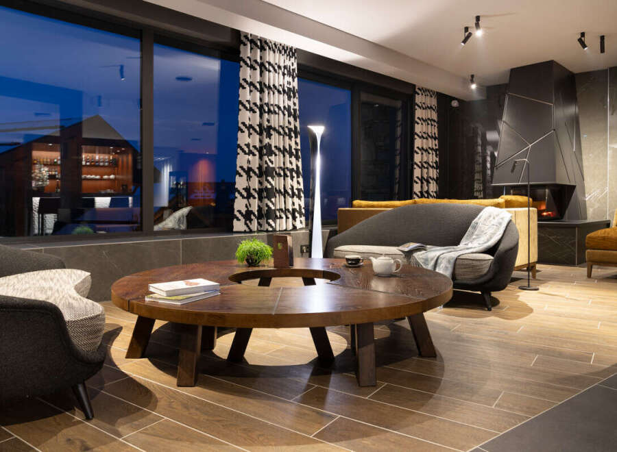 Relax in style in this luxurious lounge, featuring a stunning floor-to-ceiling window showcasing breathtaking views.