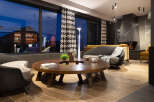 Relax in style in this luxurious lounge, featuring a stunning floor-to-ceiling window showcasing breathtaking views.
