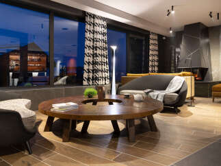 Relax in style in this luxurious lounge, featuring a stunning floor-to-ceiling window showcasing breathtaking views.
