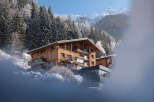 Nestled in a snowy mountainside, this stunning chalet boasts breathtaking views and luxurious accommodations.