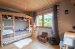 Charming wooden bunk bed in a child's bedroom with a view.