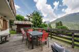 Enjoy breathtaking mountain views from this charming chalet's spacious deck.