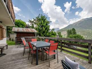 Enjoy breathtaking mountain views from this charming chalet's spacious deck.