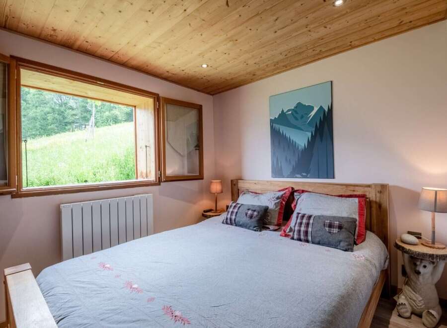 Cozy bedroom with wooden accents and mountain views.