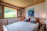 Cozy bedroom with wooden accents and mountain views.