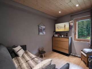 Cozy mountain chalet with a comfortable sofa bed, perfect for relaxing after a day of outdoor adventures.