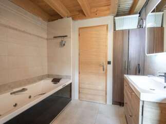 This stunning bathroom boasts a luxurious jacuzzi tub, perfect for relaxation after a long day.