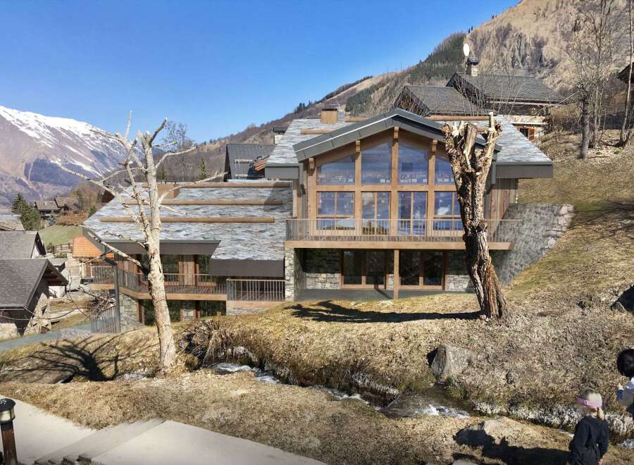 Discover a stunning mountain chalet nestled in a picturesque alpine setting.