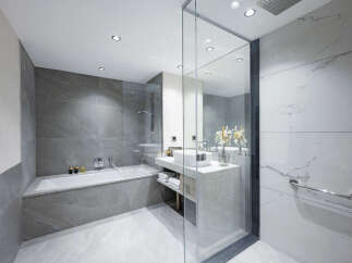 This luxurious bathroom boasts a spacious bathtub, a modern vanity with ample storage, and elegant marble tiling.