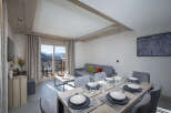 This stunning apartment boasts a spacious open-plan living area with floor-to-ceiling windows offering breathtaking mountain views.