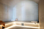 Indulge in tranquility within this exquisitely designed steam room, showcasing a calming neutral palette and sleek, modern finishes.