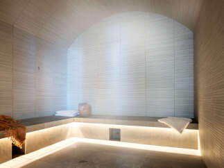 Indulge in tranquility within this exquisitely designed steam room, showcasing a calming neutral palette and sleek, modern finishes.