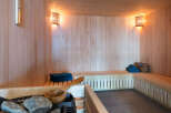 Indulge in tranquility within this exquisite sauna, meticulously crafted with premium wood paneling and featuring ambient lighting.