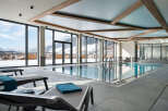 Luxury hotel indoor pool with stunning mountain views.