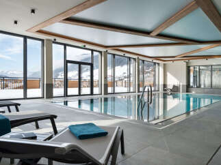 Luxury hotel indoor pool with stunning mountain views.