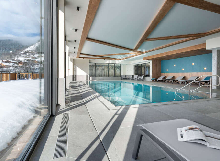 Indulge in the serene atmosphere of our indoor pool, surrounded by floor-to-ceiling windows offering breathtaking mountain views.