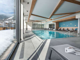 Indulge in the serene atmosphere of our indoor pool, surrounded by floor-to-ceiling windows offering breathtaking mountain views.