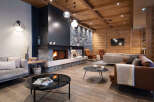 This stunning lodge boasts a spacious living area with a cozy fireplace as the centerpiece, surrounded by comfortable seating and stylish decor.