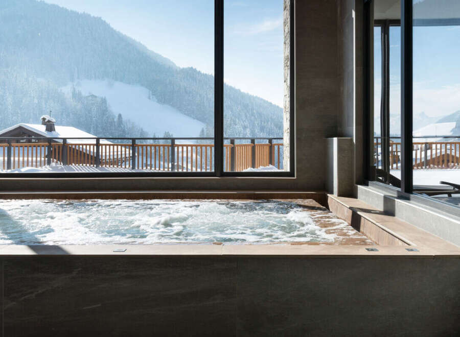 Luxury hotel hot tub with mountain views.
