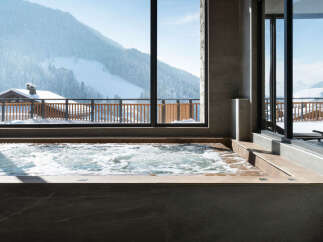 Luxury hotel hot tub with mountain views.