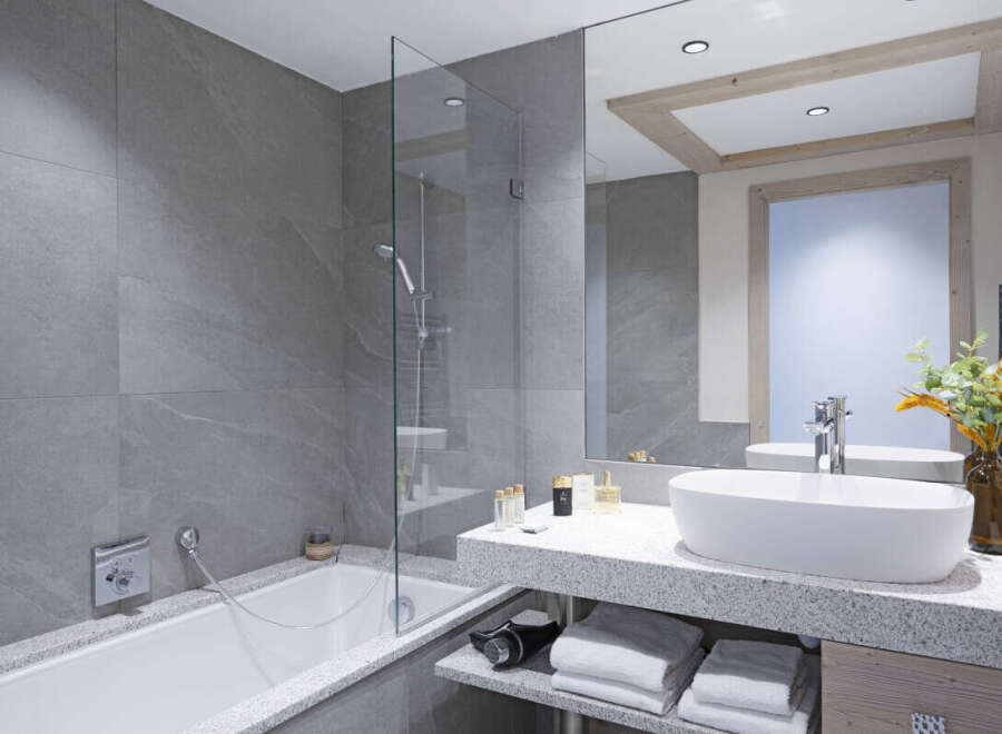 This luxurious bathroom boasts a spacious bathtub and a sleek, modern sink with plenty of counter space.