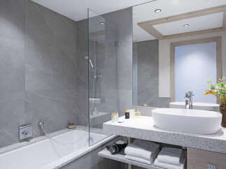 This luxurious bathroom boasts a spacious bathtub and a sleek, modern sink with plenty of counter space.