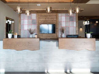 Modern hotel reception with a sleek concrete and wood design.