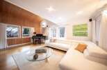 Experience luxury living in this stunning property, featuring a spacious living room with a modern white sofa.