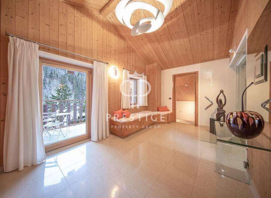 Experience luxury living in this stunning property, featuring a bright and airy interior with wooden accents.