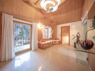 Experience luxury living in this stunning property, featuring a bright and airy interior with wooden accents.