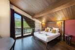Experience luxury in this stunning bedroom with breathtaking mountain views.