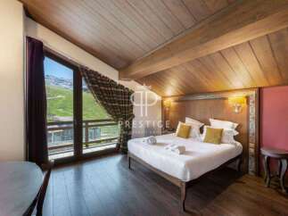 Experience luxury in this stunning bedroom with breathtaking mountain views.