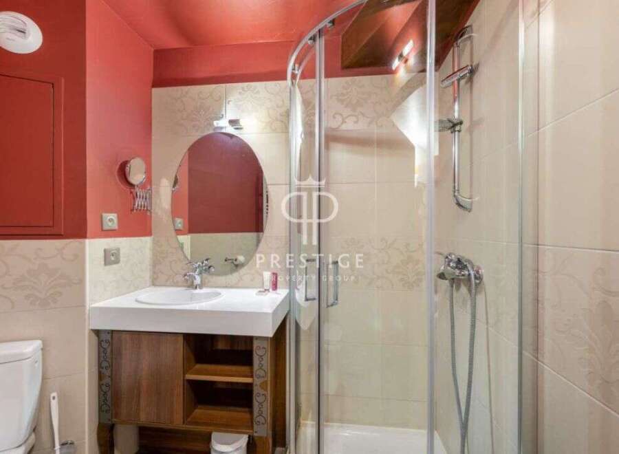 Discover a stylish bathroom featuring a modern shower and a sleek vanity.