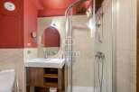 Discover a stylish bathroom featuring a modern shower and a sleek vanity.