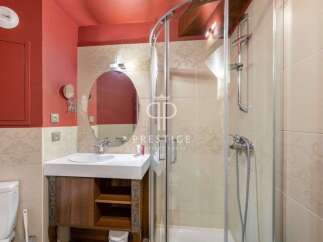 Discover a stylish bathroom featuring a modern shower and a sleek vanity.
