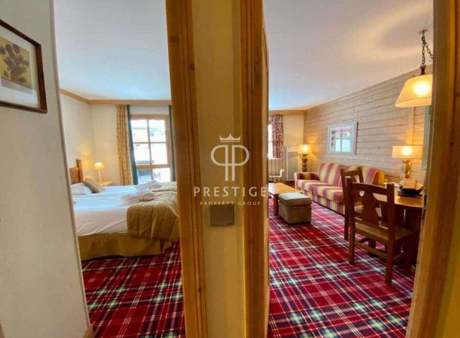 Discover the charm of this property, featuring a cozy bedroom and a welcoming living area.