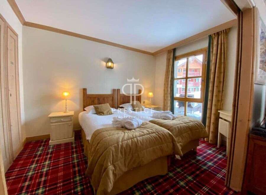 Cozy up in this charming bedroom featuring two comfortable beds, perfect for a relaxing getaway.