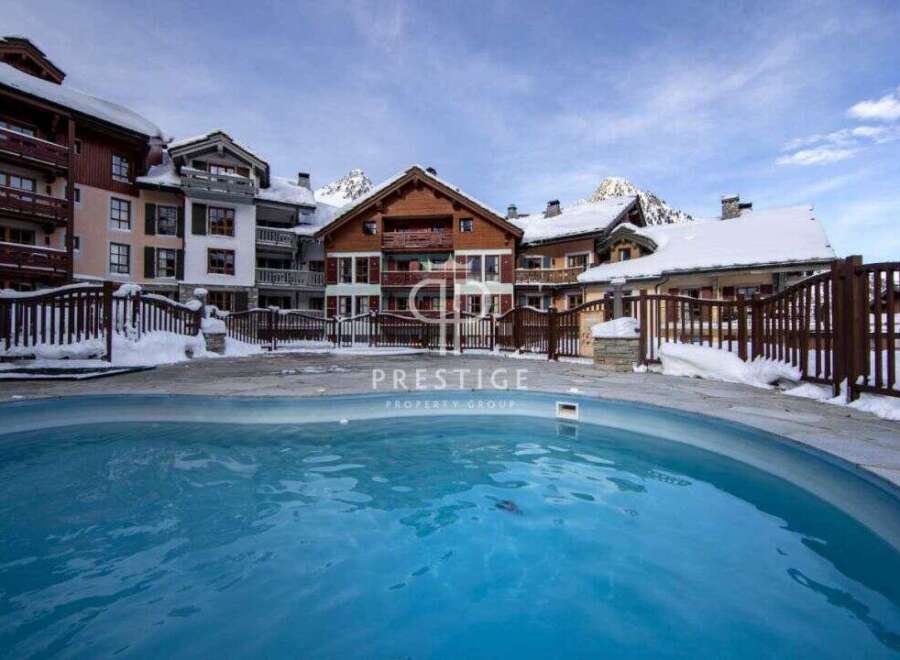 Experience luxury living in this stunning property, featuring a beautiful outdoor pool.