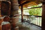 Experience rustic charm in this cozy cabin with a balcony overlooking a serene landscape.