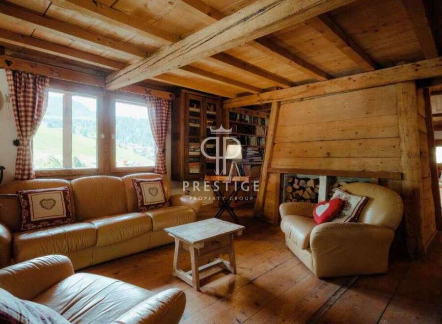 Experience rustic charm in this stunning property, featuring exposed wooden beams and a cozy fireplace.