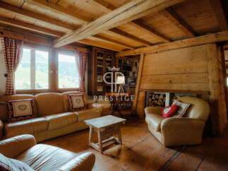 Experience rustic charm in this stunning property, featuring exposed wooden beams and a cozy fireplace.