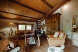 Discover the charm of this rustic property, featuring a warm and inviting living space with exposed wooden beams and a cozy fireplace.