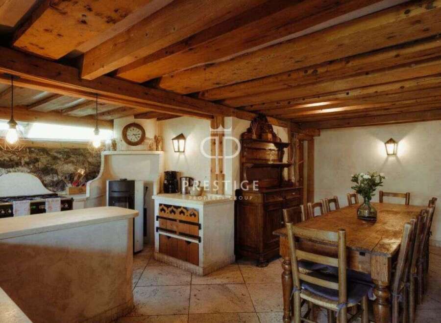 Discover rustic charm in this stunning property, featuring exposed wooden beams and a cozy ambiance.