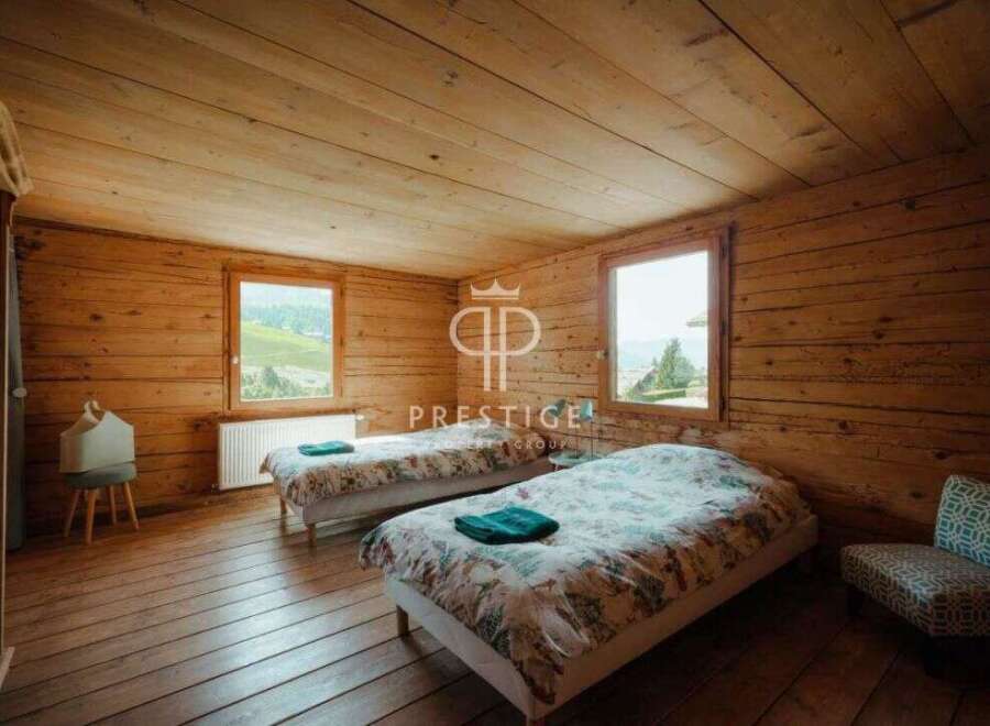 Discover the charm of this cozy bedroom, featuring rustic wooden walls and floors that exude warmth.