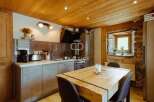 Discover the charm of this rustic kitchen, featuring a beautiful wooden ceiling and a cozy dining area.