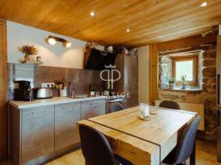 Discover the charm of this rustic kitchen, featuring a beautiful wooden ceiling and a cozy dining area.