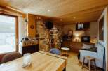 Discover the charm of this cozy property, featuring a rustic stone wall and warm wooden accents throughout.