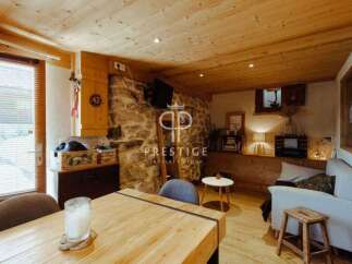 Discover the charm of this cozy property, featuring a rustic stone wall and warm wooden accents throughout.