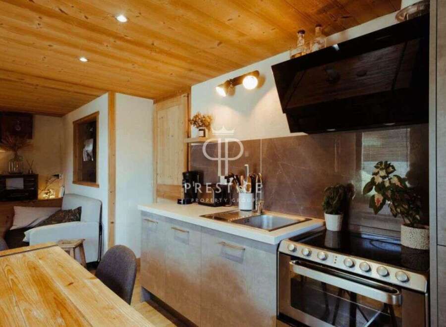 Discover the charm of this cozy kitchen, featuring a modern design with sleek cabinetry and a stainless steel oven.